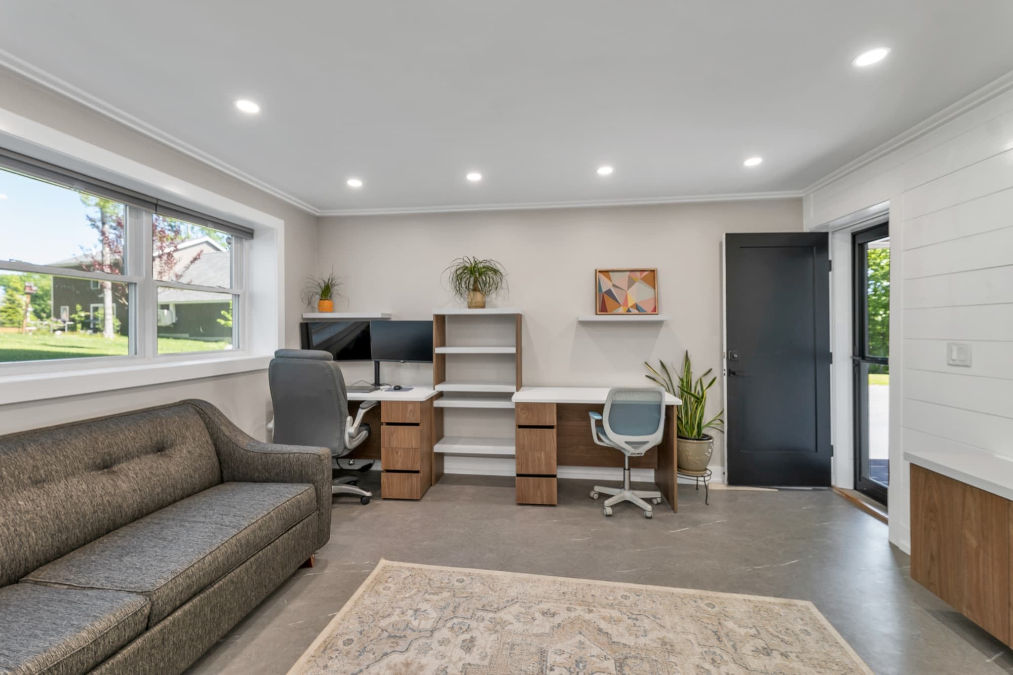 Finished lower-level office and flex space with built-in desks and walk-out access