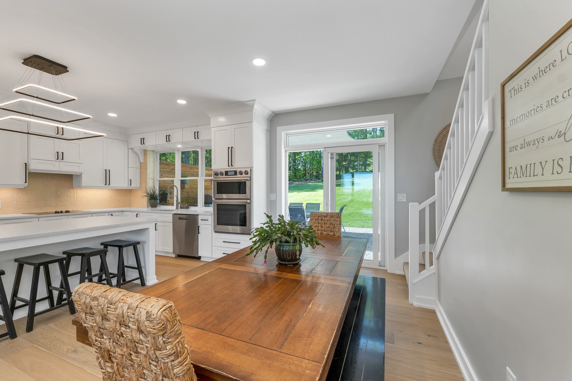 Dining area open to the kitchen with a staircase beyond