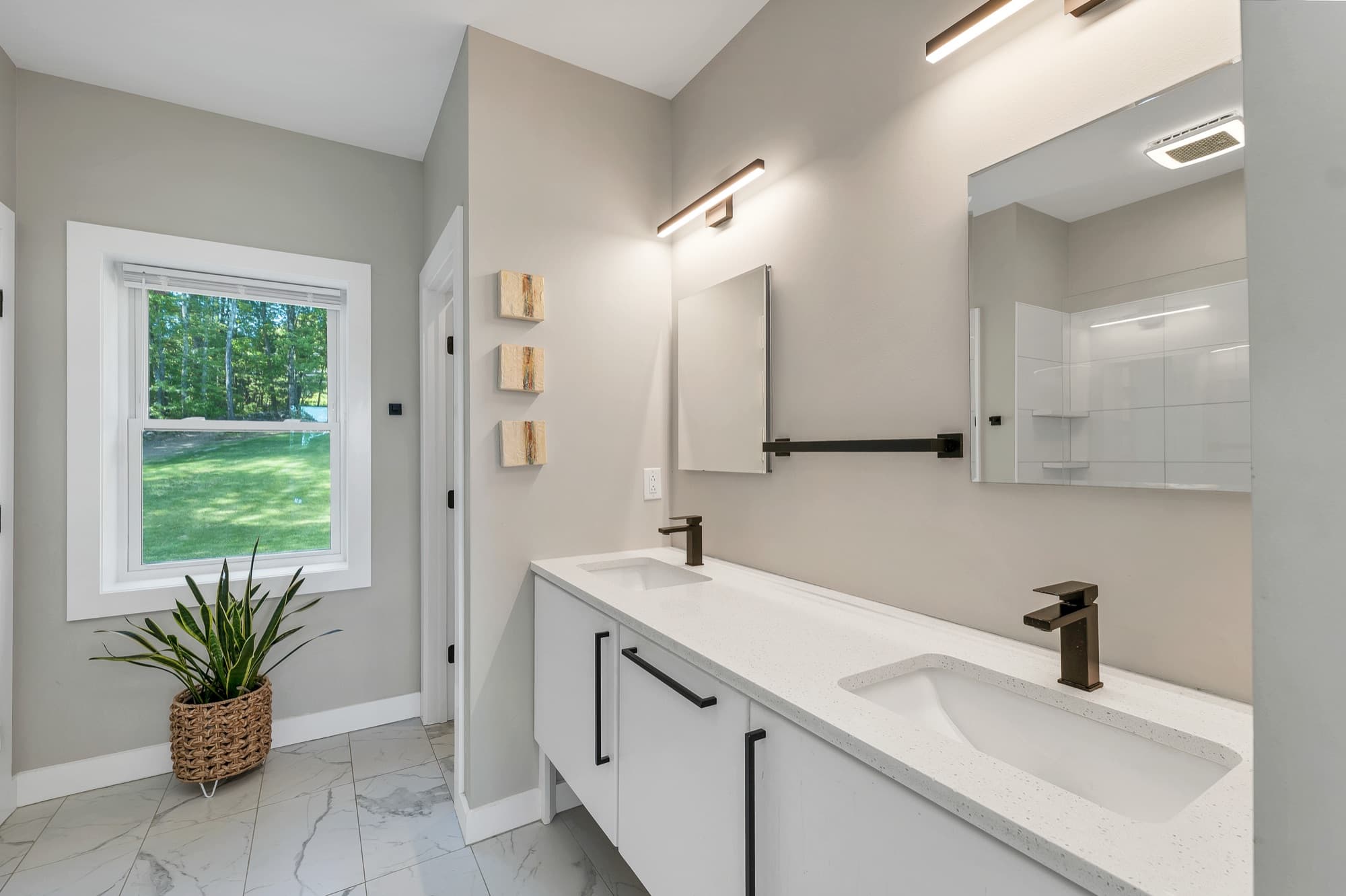 Spa-style primary bath with a double quartz vanity