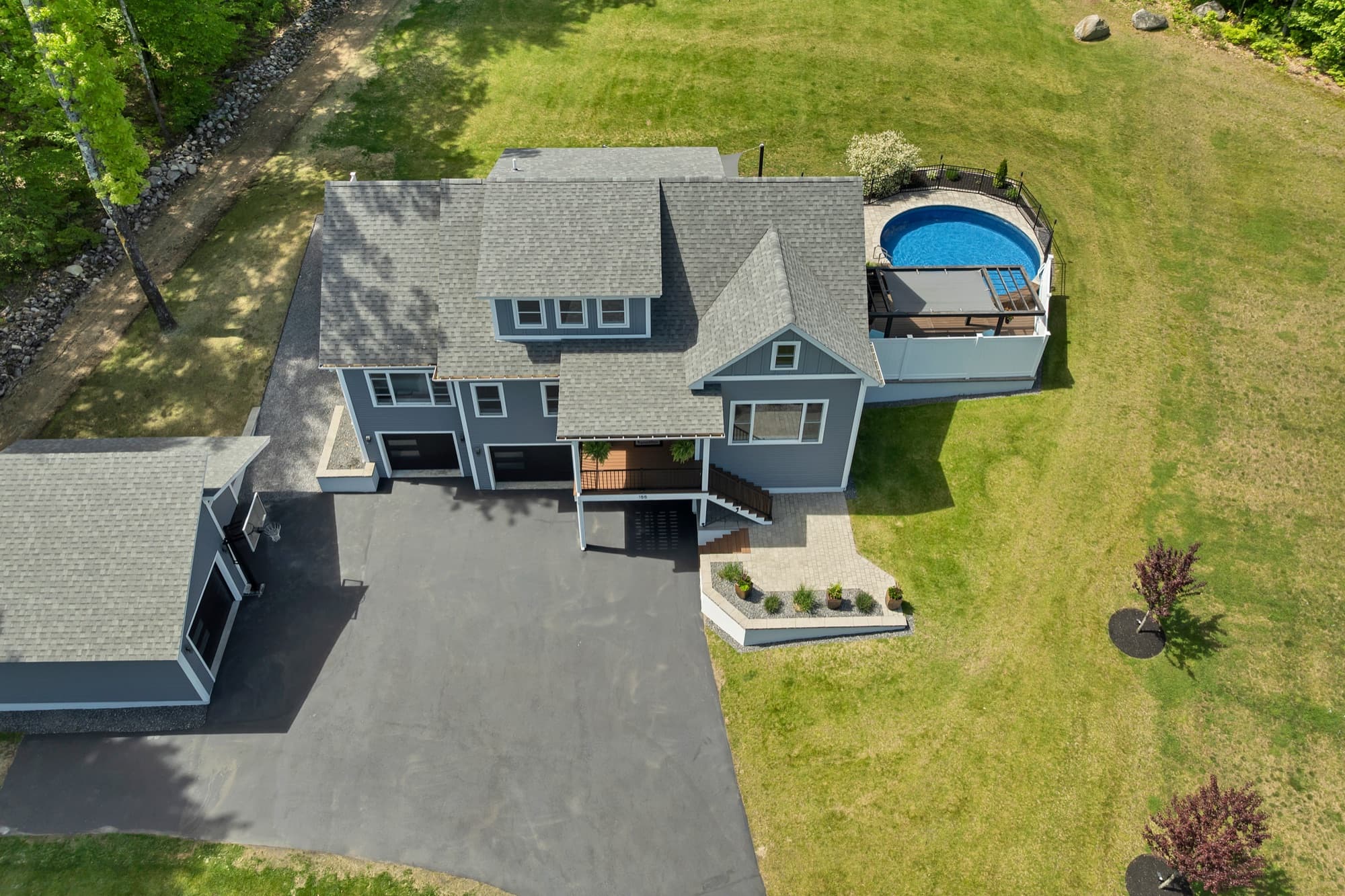 Aerial view of the home, pool, and 2.05-acre lot