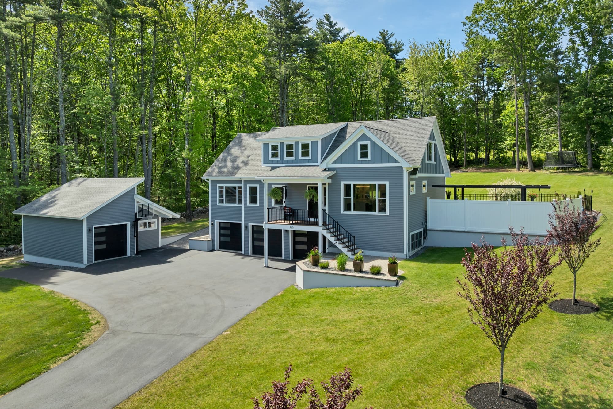 Aerial view of 155 Chesley Hill Road and the detached garage, in daylight