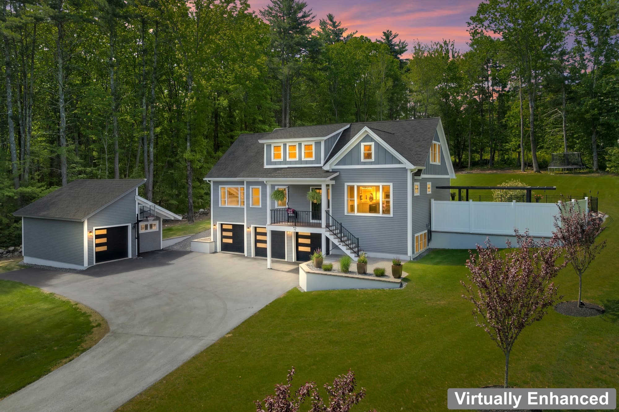 Aerial view of 155 Chesley Hill Road and the detached garage, at twilight